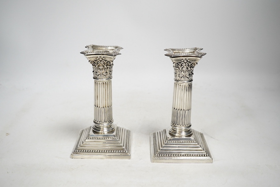 A pair of Edwardian dwarf Corinthian column silver candlesticks, by Harrison Brothers and Howson, Sheffield 1908 (loaded), 15.5cm high and a Victorian silver pedestal sugar bowl by Jacobes J Oosterbaan, London 1878, 148g